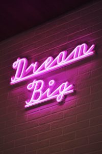 Neon text on wall saying dream big